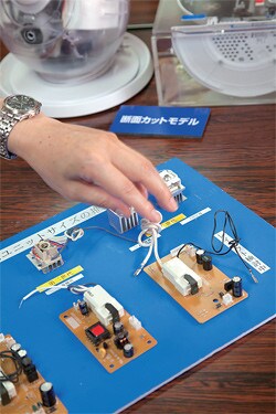 弱酸性で美肌効果が高く、髪にツヤを与える「nanoe」デバイス(指の右手にある四角い形状のもの)。脱臭効果、カビやウイルス活性の抑制効果などもある。パナソニックのドライヤー、エアコン、冷蔵庫、空気清浄機などの一部に搭載されている。