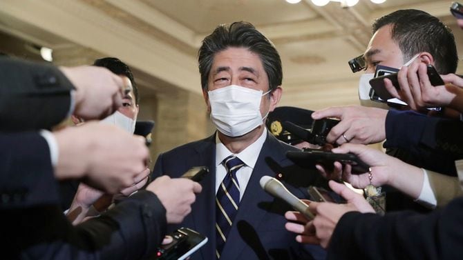 「桜を見る会」をめぐる問題について記者団の質問に答える安倍晋三前首相（中央）＝2020年12月4日、国会内