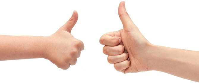 親指を立てる大人と子どもの手