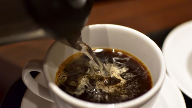 白いカップでコーヒーをいれる