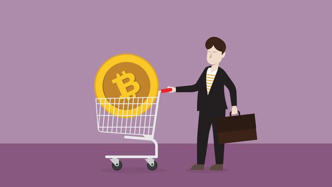 ショッピングカートにビットコインを積んだビジネスマン