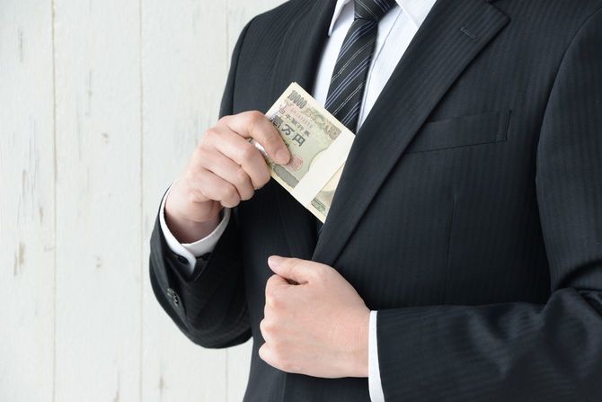 札束を着服している男性