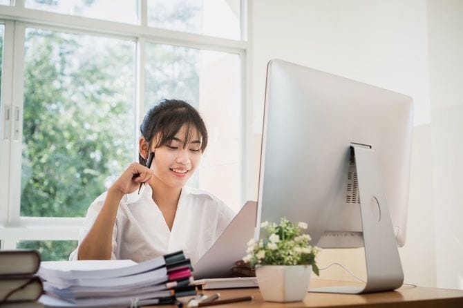 女性のオフィスドキュメントの作業を確認します