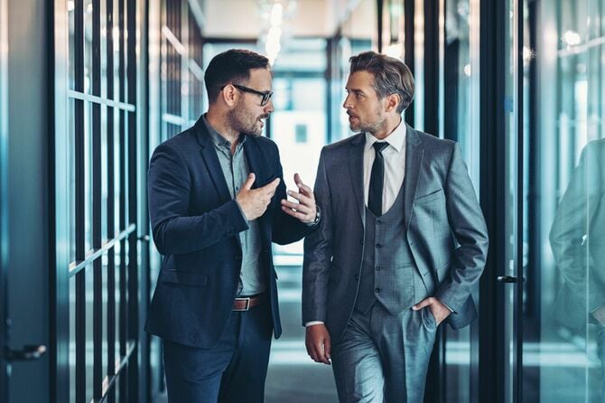 廊下で話し合うビジネスマンたち