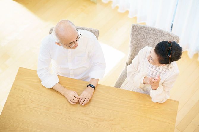 リビングでおしゃべりするシニアカップル