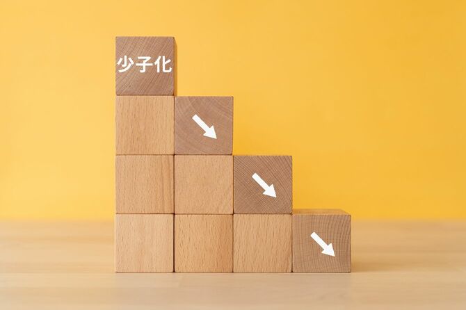 木製ブロックに「少子化」の文字。右肩下がりで下降を示している