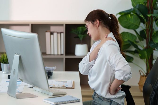 肩を押さえている若い女性