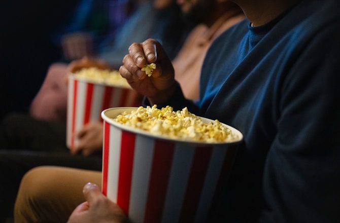 ポップコーンを食べながら映画を見る客