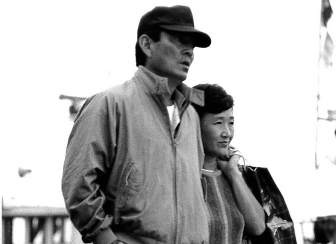 『居酒屋兆治』の撮影風景。加藤さんが高倉さんと腕を組んで歩いた思い出のシーン