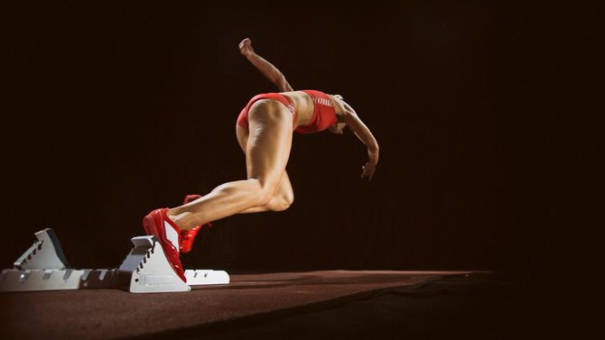 トラックを走り出す女性アスリート