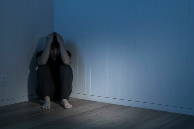 暗い部屋で途方に暮れた男