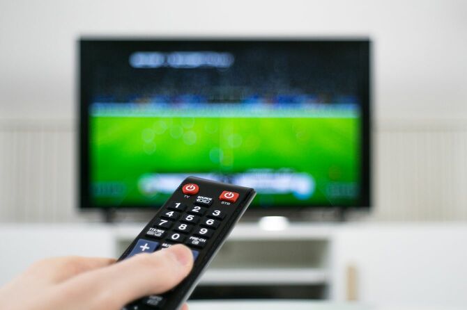 サッカーの中継からチャンネルを変えようとしている手元