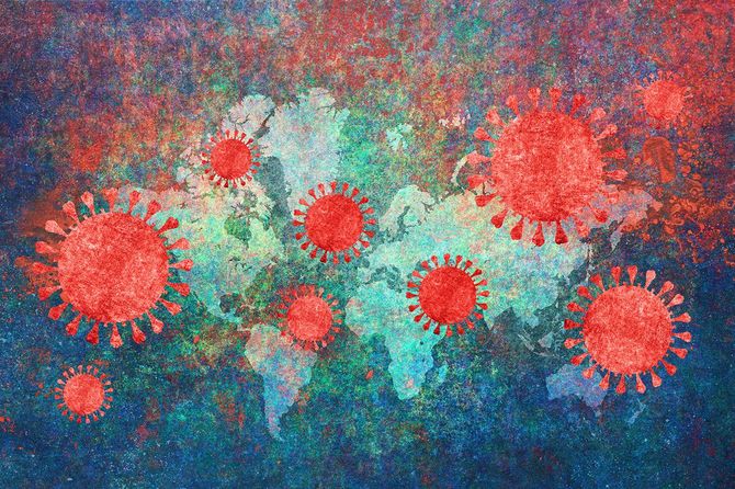 背景に世界地図を持つコロナウイルス