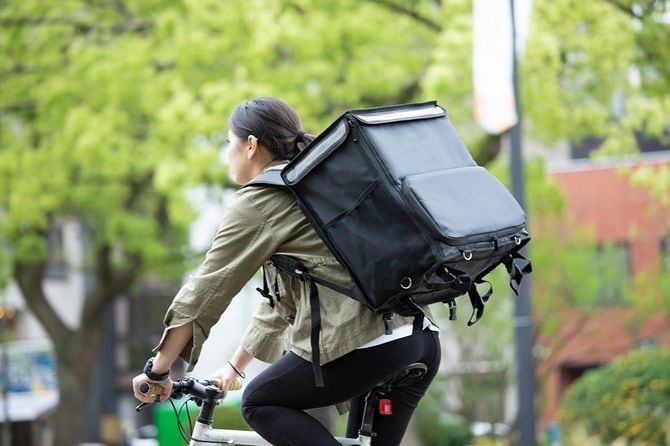 自転車で配達の仕事をする人