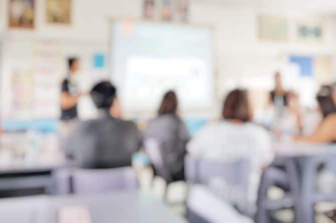 授業参観日に教室に親が着席している、ボカシのかかった写真