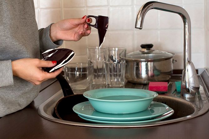 壊れたカップを持つ若い女性