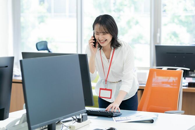 オフィスでスマートフォンを持つビジネスウーマン