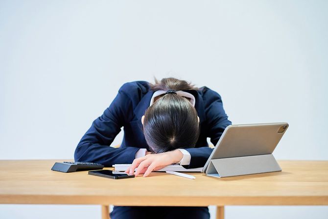 疲れた様子のスーツ姿の女性