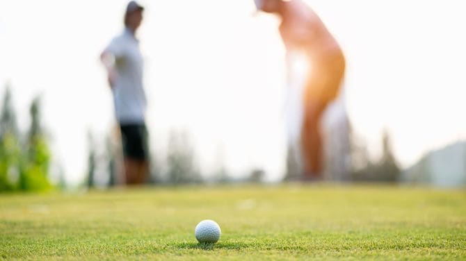 カップルでゴルフ プレーヤー置くゴルフボール 
