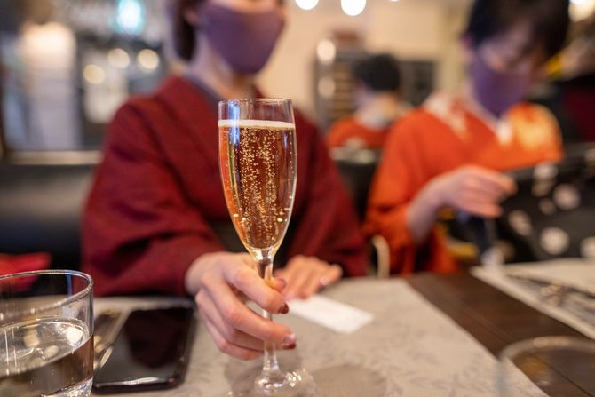シャンパングラスを手にする着物姿の女性