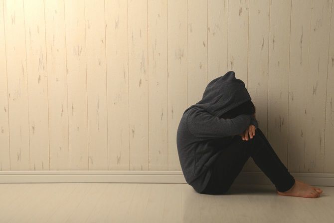 暗い部屋で苦しんでいる子