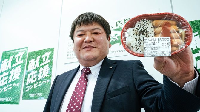 ウインナー弁当を掲げる林弘昭さん
