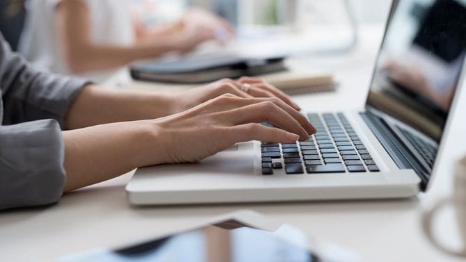 ノートパソコンを使用する手元