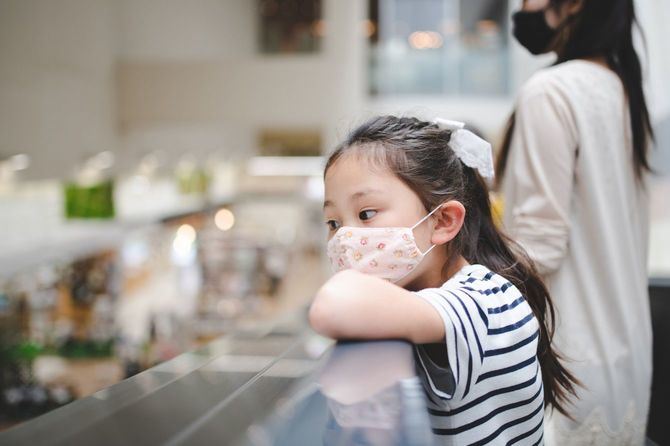 マスクを着用して買い物をする親子