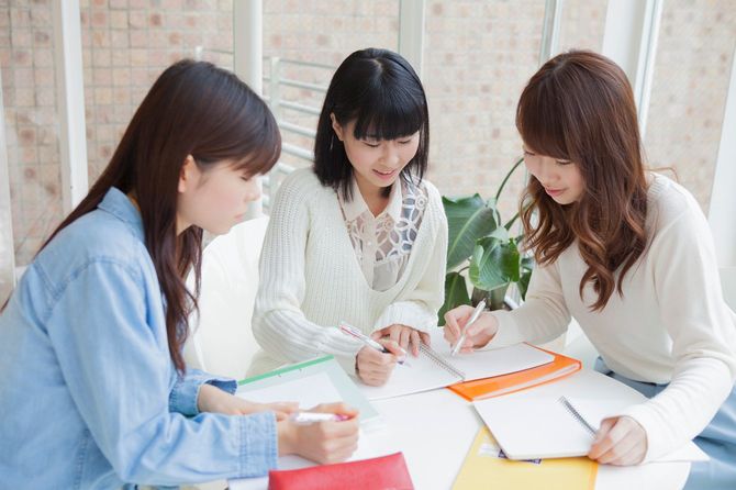 Three young Japanese women studying