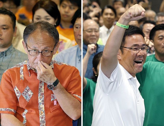 沖縄県知事選で初当選を決め、気勢を上げる古謝玄太氏（右）と、落選が決まり厳しい表情の玉城デニー氏＝2026年9月13日夜、那覇市