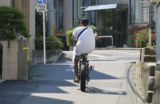 足を組んだままスロットルで爆走する「フル電動自転車」