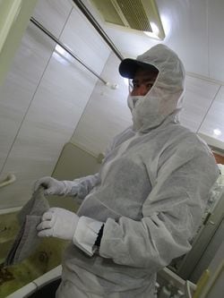 生前遺品整理会社「あんしんネット」の作業員・大島英充さん。事故防止のため防護服に身を包んでいる。