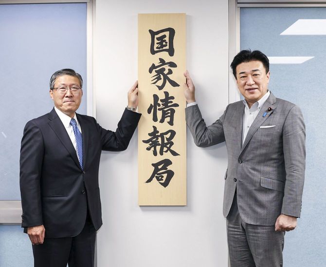 「国家情報局」の看板をかける原和也国家情報局長(左)と木原官房長官=2026年7月31日(内閣広報室提供)