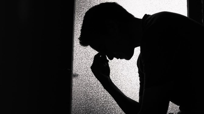 悲しむ男性のシルエット