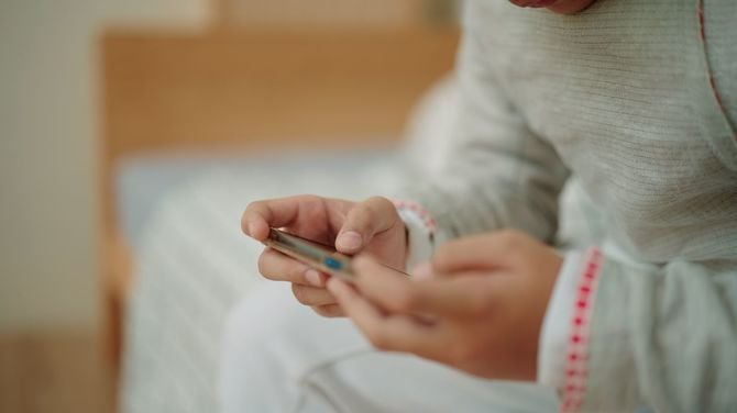 スマホでゲームをする子供