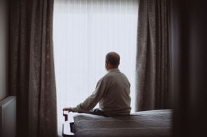 ベッドに座っている高齢の男性