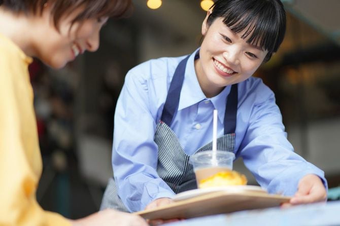 デザートを提供する女性店員