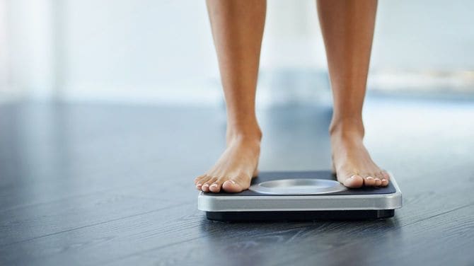 体重計に乗る女性の足元