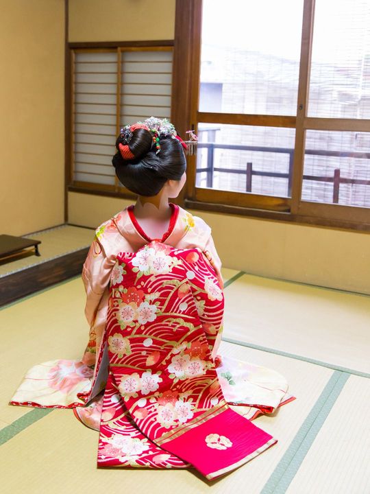 和室に正座している舞妓さん