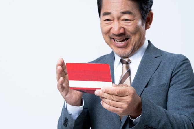 通帳を見て笑顔の男性