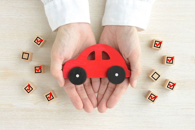 木製ブロックのミニチュアカーを大事そうに掌に載せている