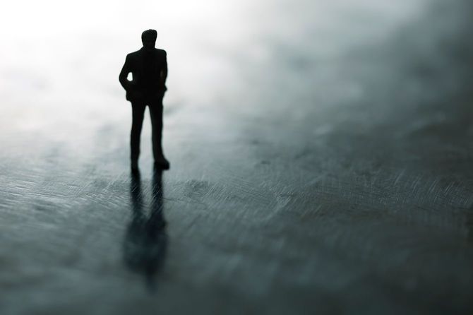 メタリックな地面に立つ男性のシルエット