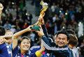 ワールドカップの優勝トロフィーを高々と掲げる佐々木監督と澤選手（ロイター／AFLO＝写真）。