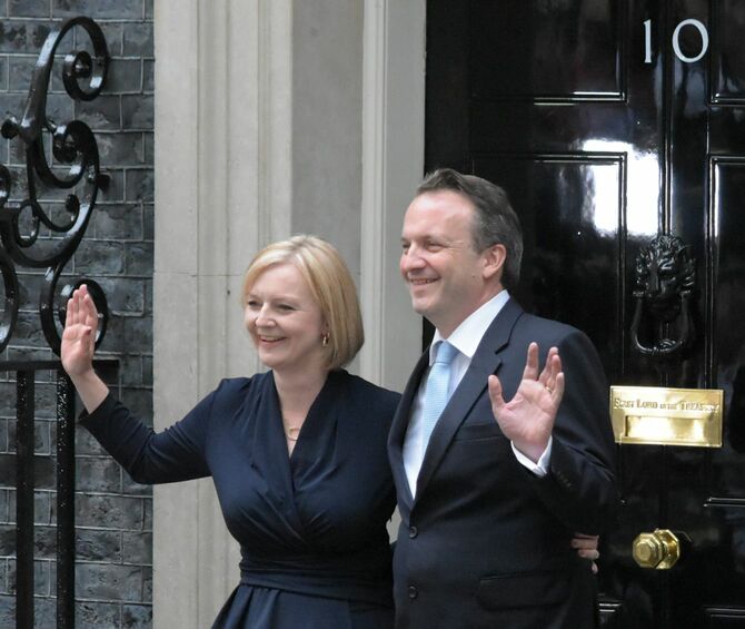 漆黒の扉に「10」と記された英首相官邸に入るリズ・トラス英首相と夫のヒュー・オレアリー氏（2022年9月6日）