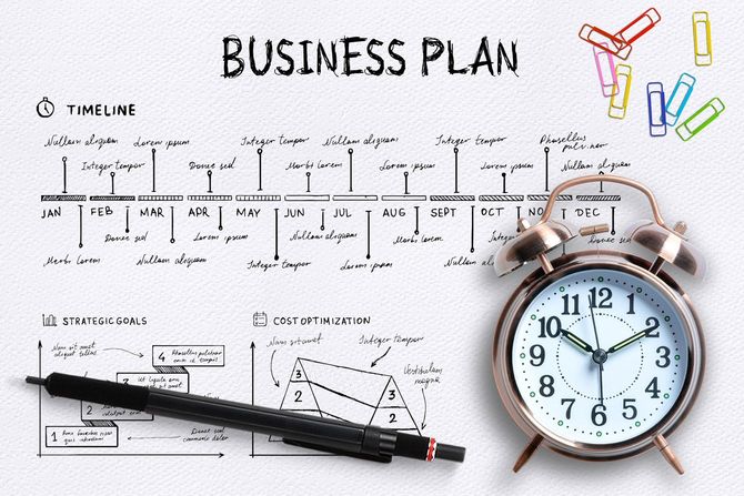 ビジネスプランの表と目覚まし時計