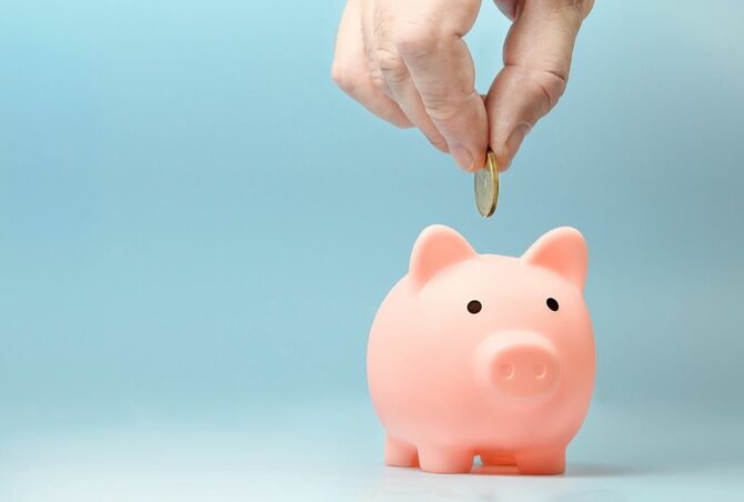 貯金箱にコインを入れる