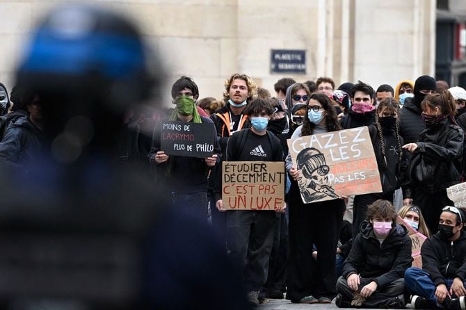 2026年10月8日、フランス東部のナンシーで行われた学生デモの最中、学習環境をめぐる全国的な抗議運動の一環として、あるデモ参加者が警察の前で「適切な環境で学ぶことは贅沢ではない」と書かれたプラカード(中央)を掲げている。