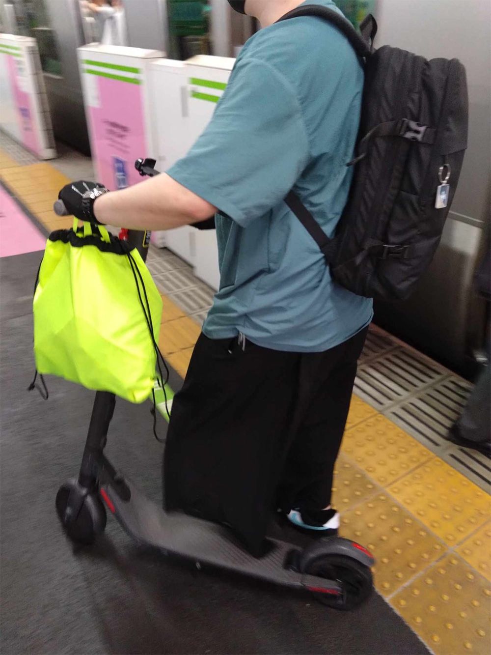 【写真3】駅に降りてすぐに電動キックに乗る男性