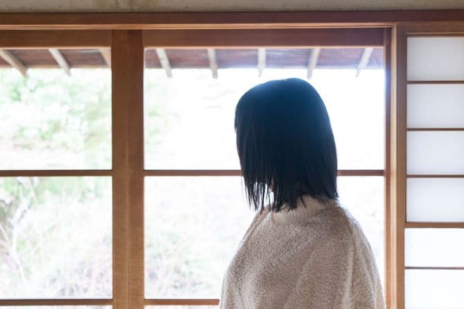 振り替えって庭を眺めている女性
