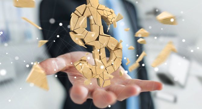 ビジネスマンの手のひらの上のドル記号が砕け散るイメージ画像